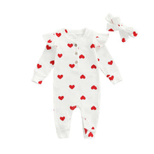 Heart print baby romper worn by a baby girl