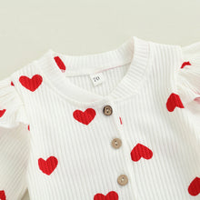 Heart print baby romper worn by a baby girl