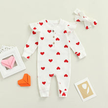 Heart print baby romper worn by a baby girl