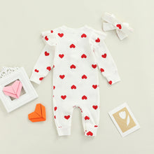 Heart print baby romper worn by a baby girl