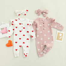 Heart print baby romper worn by a baby girl