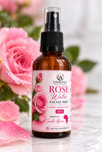 W Cosmetics rose facial mist 50ml amber spray bottle with a pink floral label beside pink roses