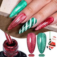Christmas-themed glitter nail polish set shown on a hand with long stiletto nails, alongside a bottle of red glitter polish and two sample nail swatches labeled DC573 and DC574.