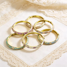 Flower enamel bracelet worn on wrist showing vibrant colour finish.