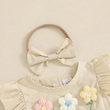  Embroidered baby romper worn by a baby girl