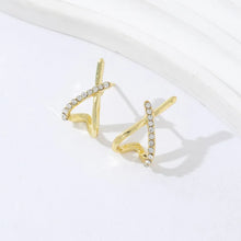 Gold cross stud earrings available at Her Wardrobe & Beyond.