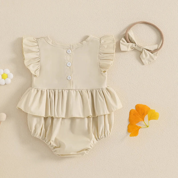  Embroidered baby romper worn by a baby girl