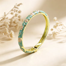 Flower enamel bracelet worn on wrist showing vibrant colour finish.