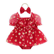 Daisy print baby romper worn by a baby girl