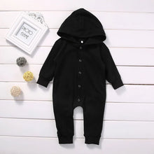 Black baby romper worn by a baby boy
