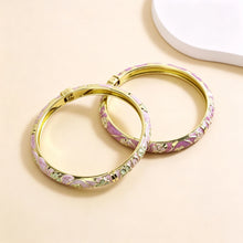Flower enamel bracelet worn on wrist showing vibrant colour finish.