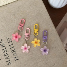 Flower keychain resin pendant attached to car keys styling shot.