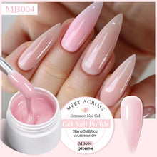 Pink gel nail polish being applied with a brush, showing a close-up of nails with pink and beige gradient design.