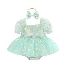 Daisy print baby romper worn by a baby girl