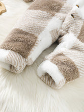  Hooded baby jumpsuit worn by a baby