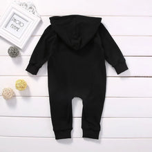 Black baby romper worn by a baby boy