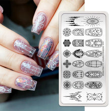 Nail stamping plates close-up showing deeply etched flower designs.