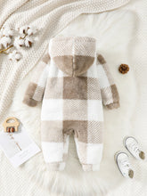  Hooded baby jumpsuit worn by a baby