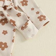 Baby girl floral jumpsuit worn by a baby girl