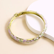 Flower enamel bracelet worn on wrist showing vibrant colour finish.