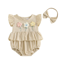  Embroidered baby romper worn by a baby girl