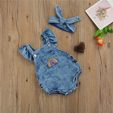 Baby denim romper worn by a baby girl