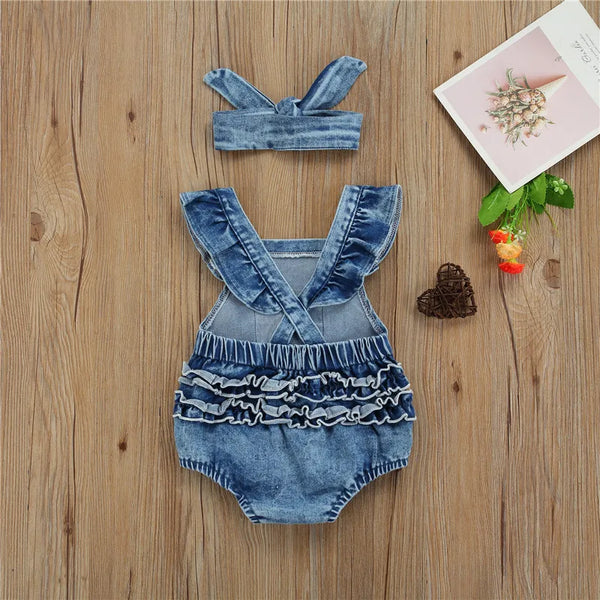 Baby denim romper worn by a baby girl