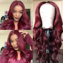 Model wearing curly wine red long wig at a fashion party event.