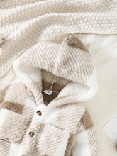  Hooded baby jumpsuit worn by a baby