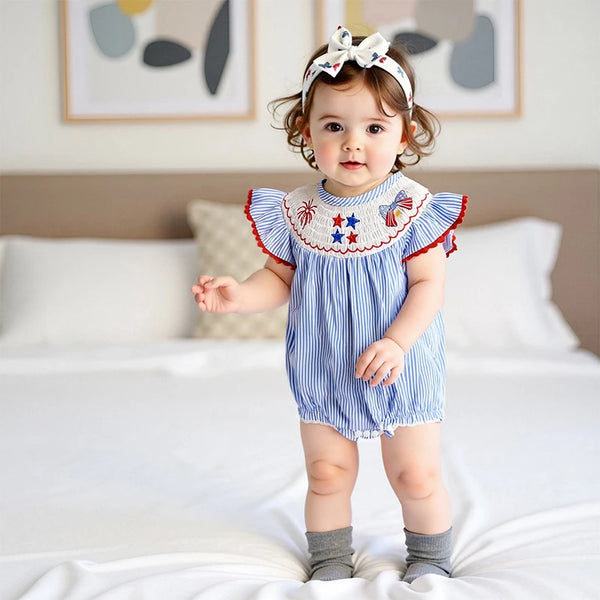 Striped baby romper worn by a baby girl