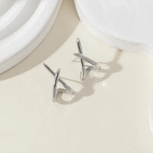 Gold cross stud earrings available at Her Wardrobe & Beyond.