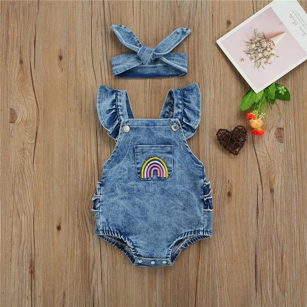 Baby denim romper worn by a baby girl
