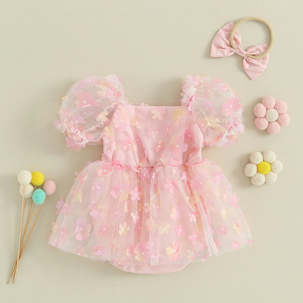 Baby girl romper dress worn by a baby girl