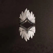 Angel wings ring adjustable showing intricate wing detail close-up.