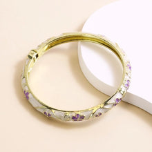 Flower enamel bracelet worn on wrist showing vibrant colour finish.