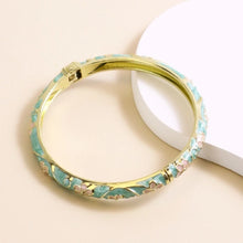 Flower enamel bracelet worn on wrist showing vibrant colour finish.