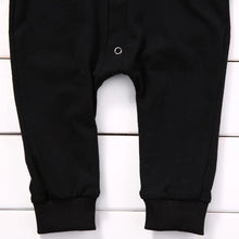 Black baby romper worn by a baby boy