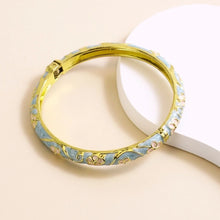 Flower enamel bracelet worn on wrist showing vibrant colour finish.