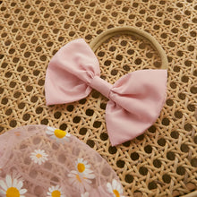 Daisy print baby romper worn by a baby girl