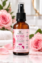 W Cosmetics rose facial mist 50ml amber spray bottle with a pink floral label beside pink roses